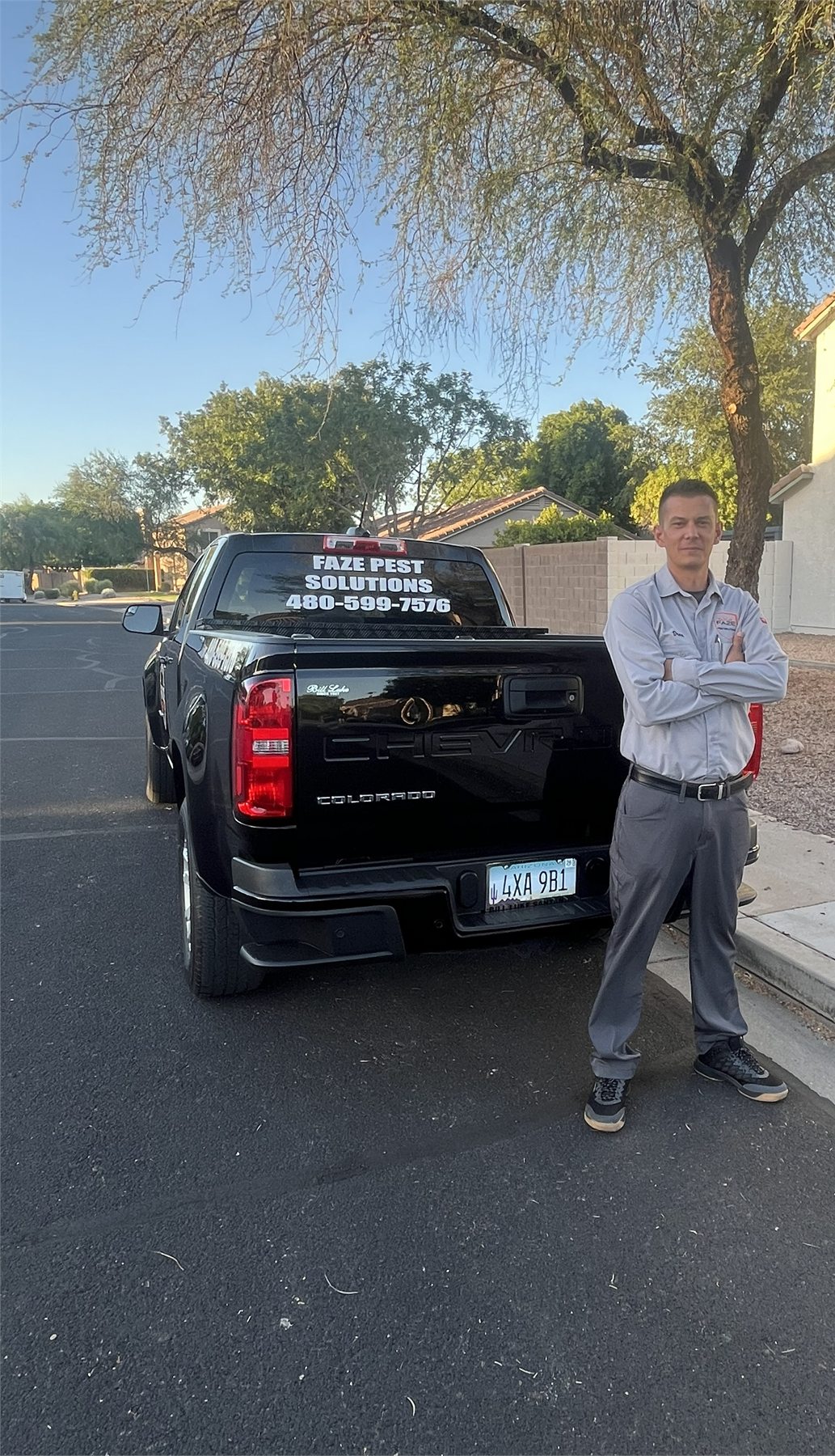 Drew, owner of Faze Pest Solutions, standing beside the branded pest control truck