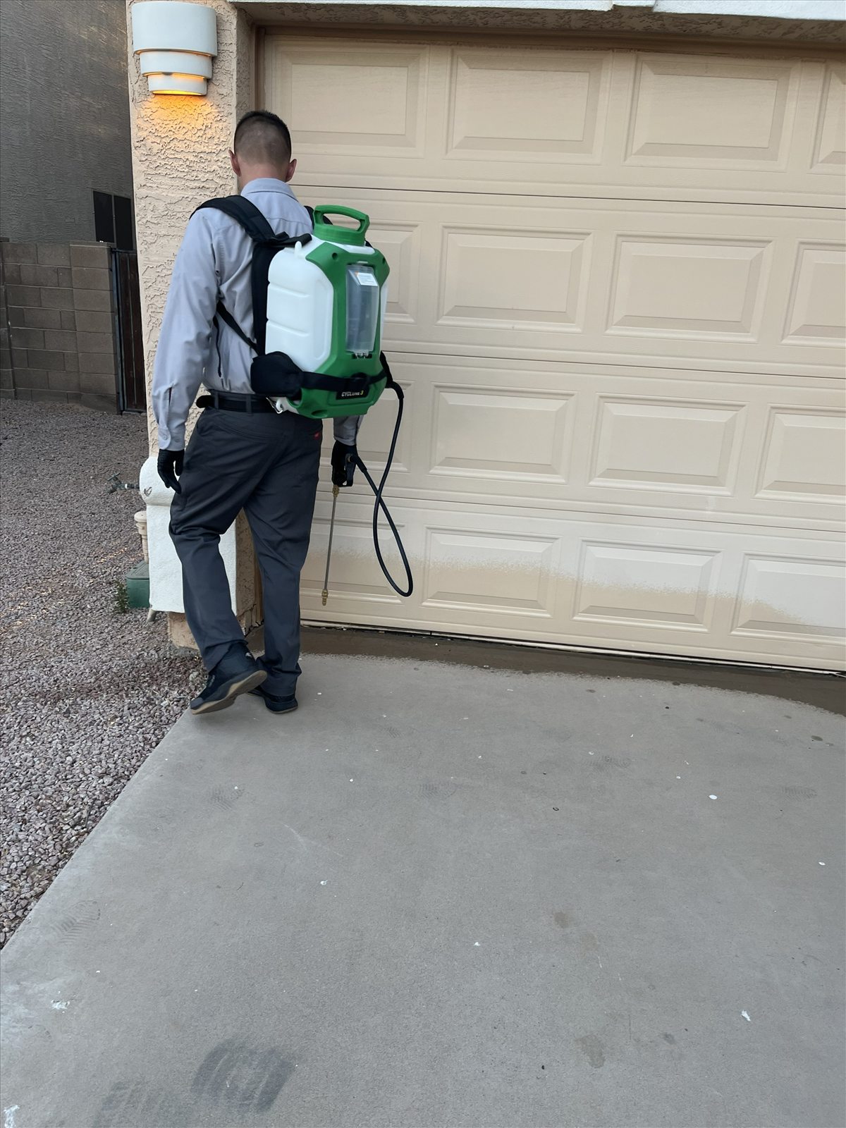 Exterior garage perimeter pest control treatment at an East Valley home